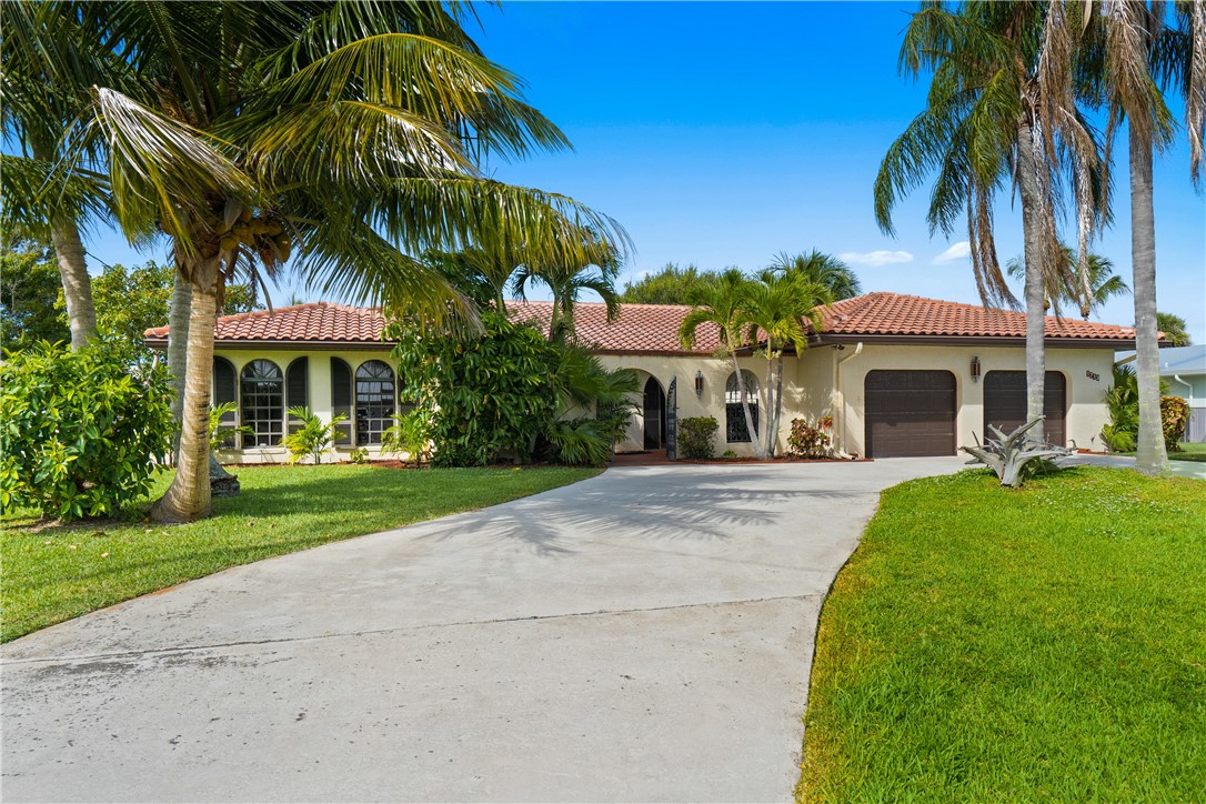 1713 Sunset Isles Road Fort Pierce, FL 34949 - Photo 3 of 36 front view of a house with a yard