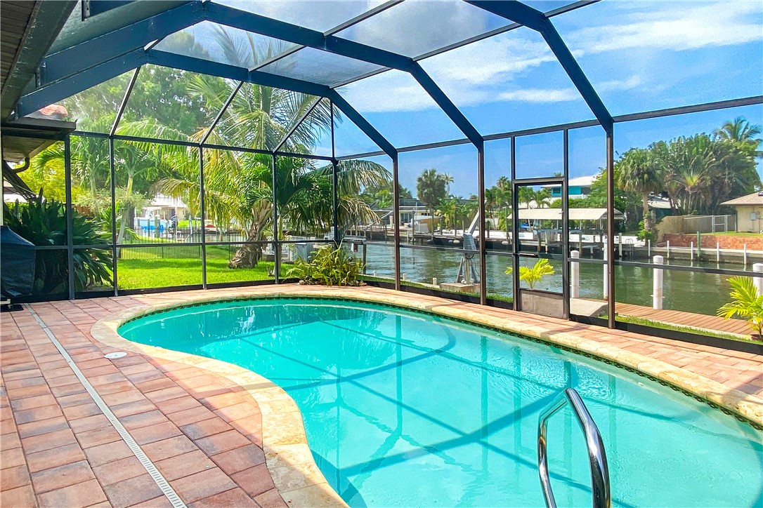 1713 Sunset Isles Road Fort Pierce, FL 34949 - Photo 31 of 36 a view of a backyard with a swimming pool