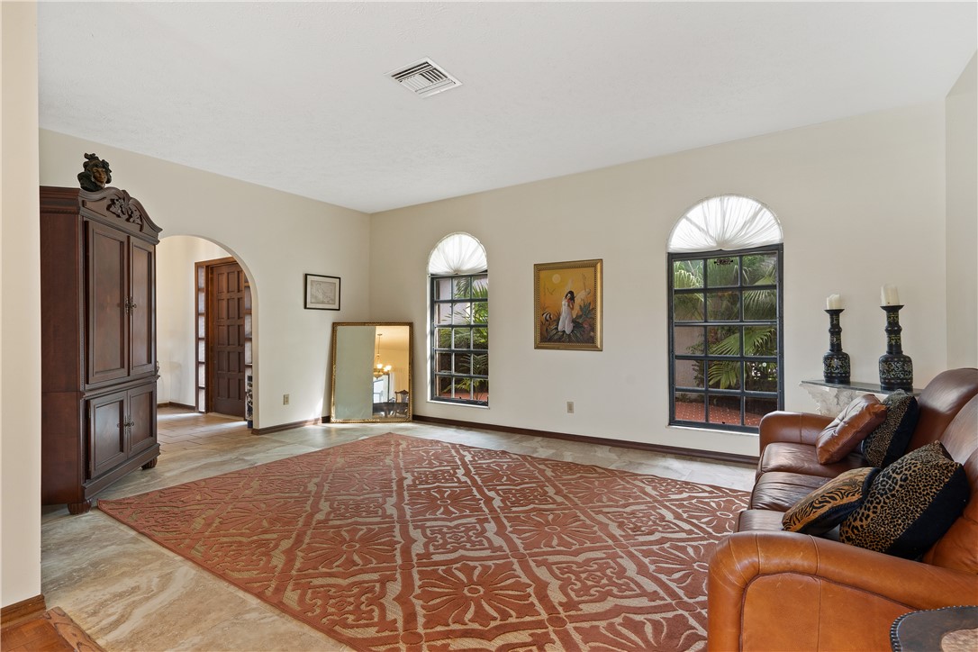 1713 Sunset Isles Road Fort Pierce, FL 34949 - Photo 6 of 36 a living room with furniture a window and a chandelier