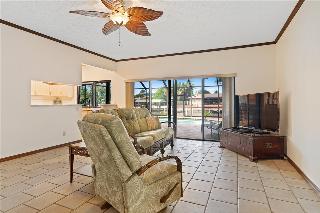 1713 Sunset Isles Road Fort Pierce, FL 34949 - Photo 8 of 36 a living room with furniture and a flat screen tv