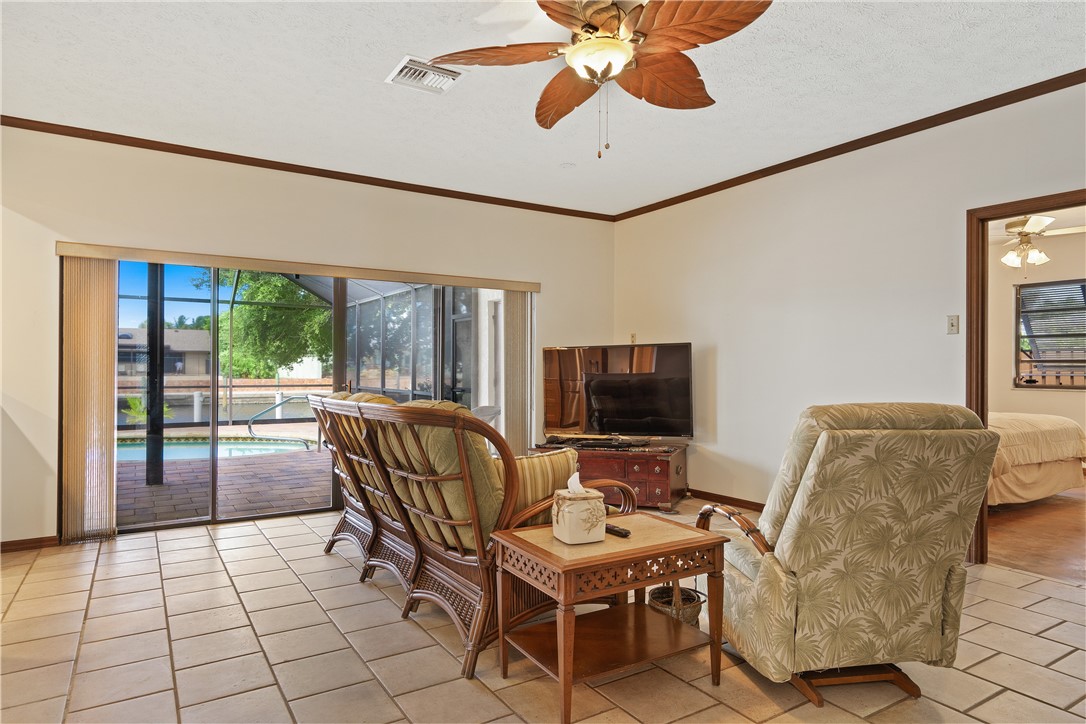 1713 Sunset Isles Road Fort Pierce, FL 34949 - Photo 9 of 36 a living room with furniture and a flat screen tv