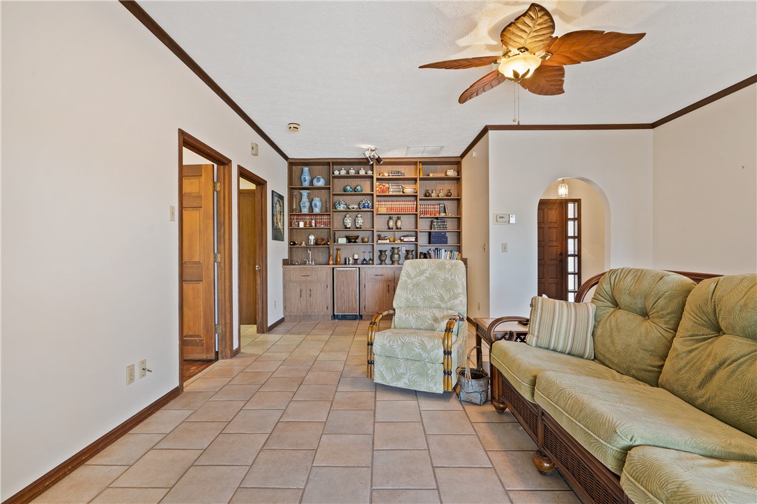 1713 Sunset Isles Road Fort Pierce, FL 34949 - Photo 10 of 36 a living room with furniture and a flat screen tv