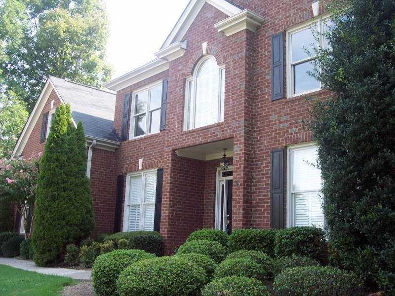 a view of a brick building next to a yard
