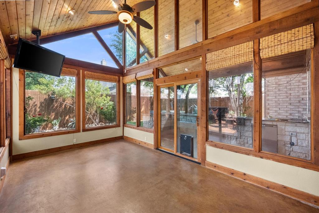 1305 Liverpool Lane Mansfield, TX 76063 - Photo 32 of 40 This sunroom features expansive windows with wooden frames and a high vaulted ceiling with wooden paneling