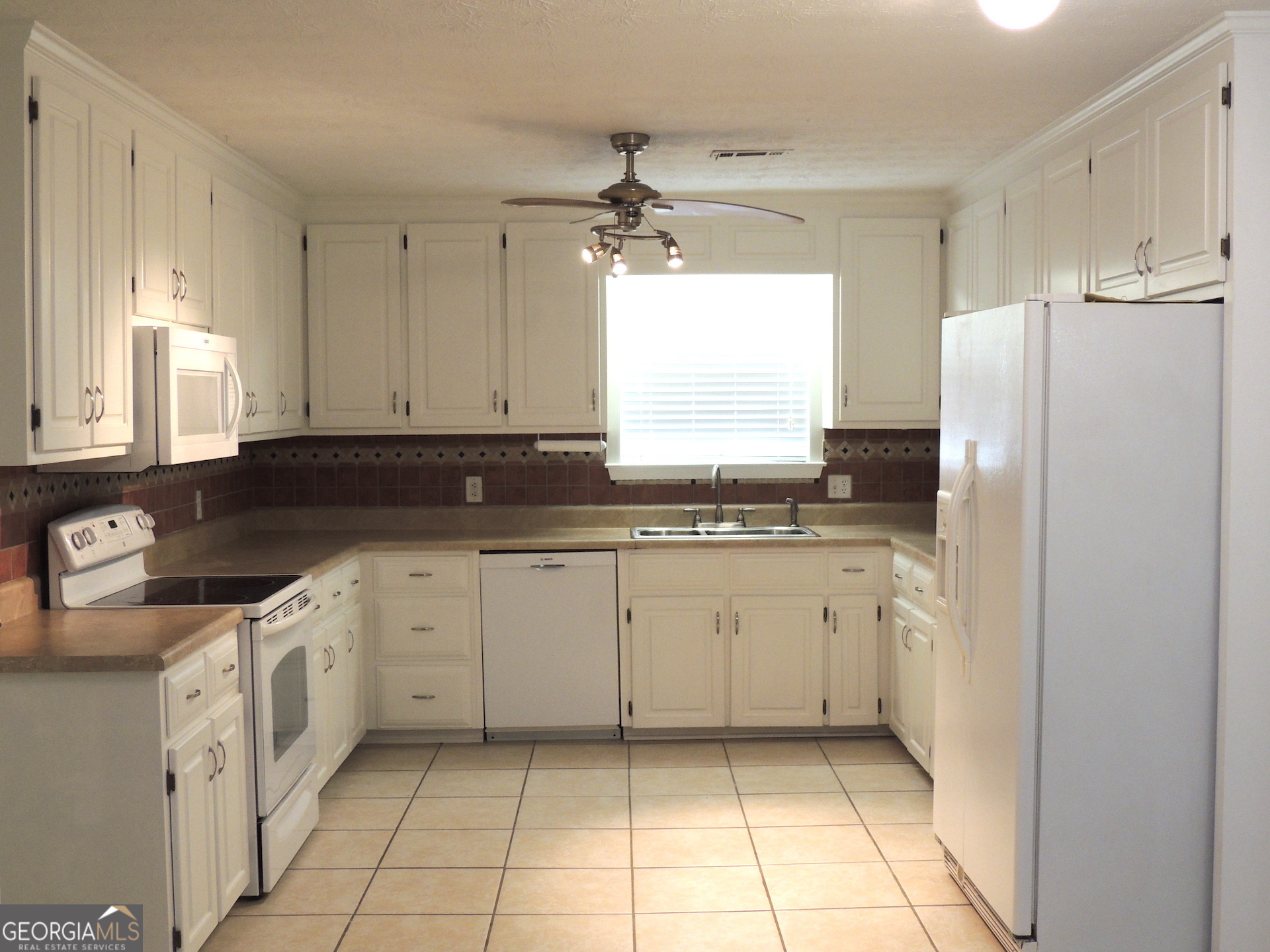 10 Brandon Drive Covington, GA 30016 - Photo 2 of 13 a kitchen with granite countertop a sink window and refrigerator