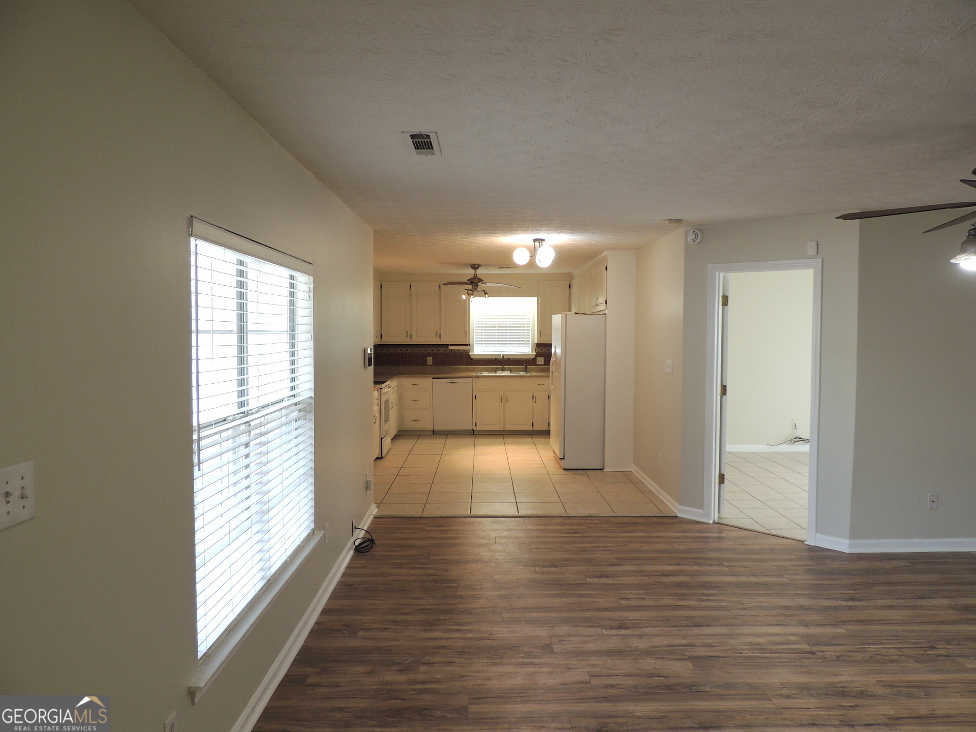 10 Brandon Drive Covington, GA 30016 - Photo 3 of 13 a view of a hallway with wooden floor and a living room
