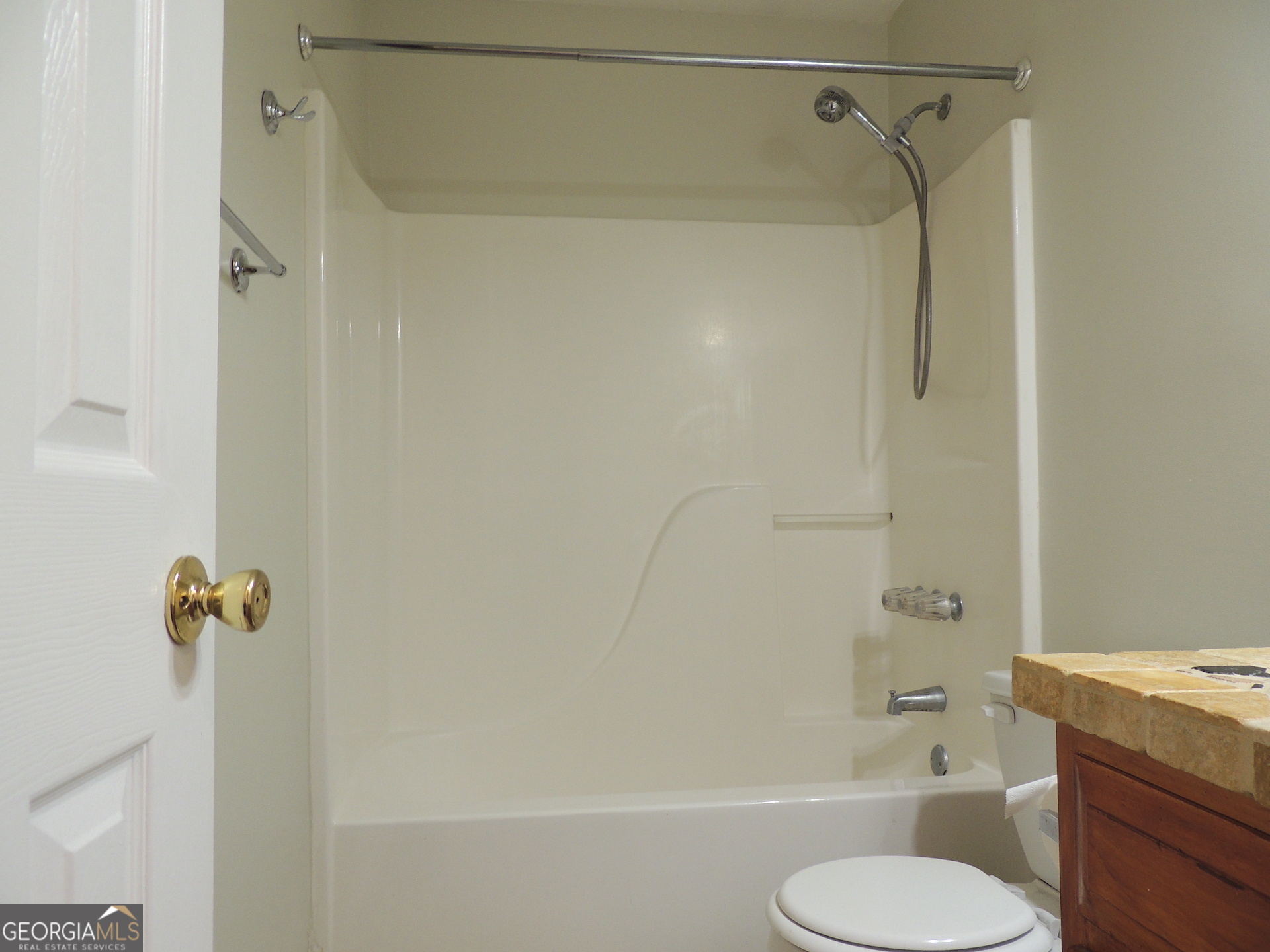 10 Brandon Drive Covington, GA 30016 - Photo 6 of 13 a bathroom with a shower and a toilet