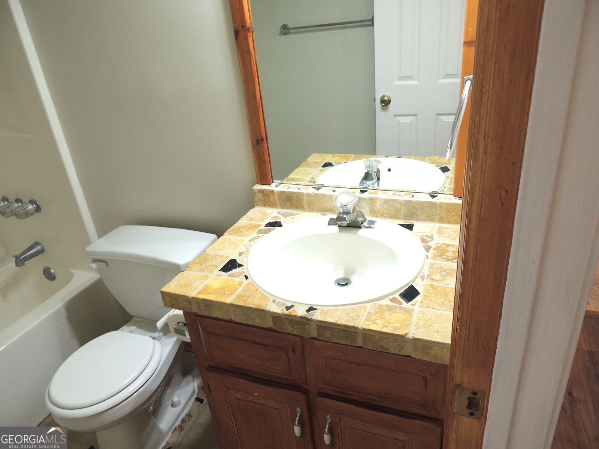 10 Brandon Drive Covington, GA 30016 - Photo 7 of 13 a bathroom with a sink a toilet and mirror