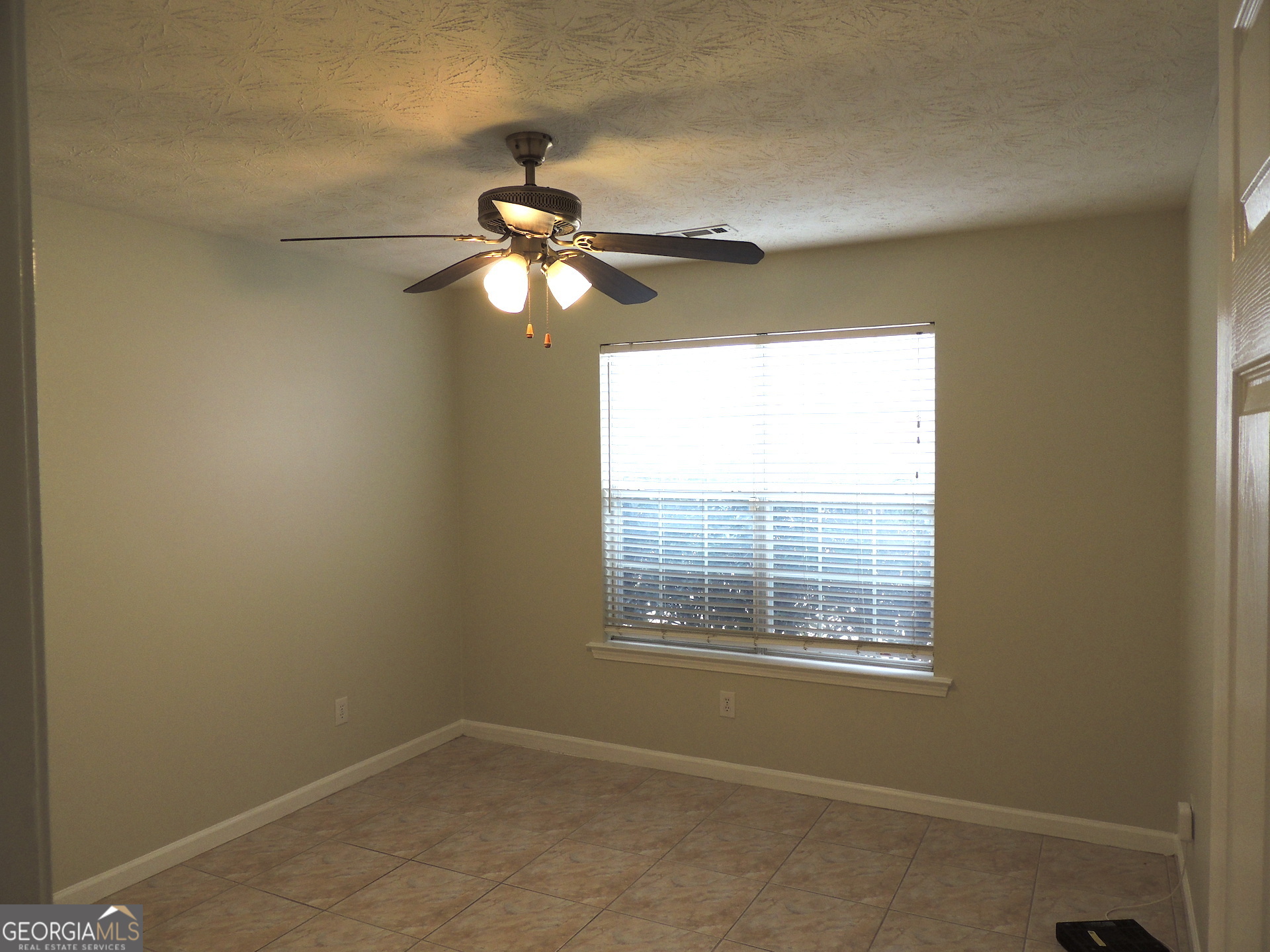 10 Brandon Drive Covington, GA 30016 - Photo 8 of 13 a view of a room with a ceiling fan and a window