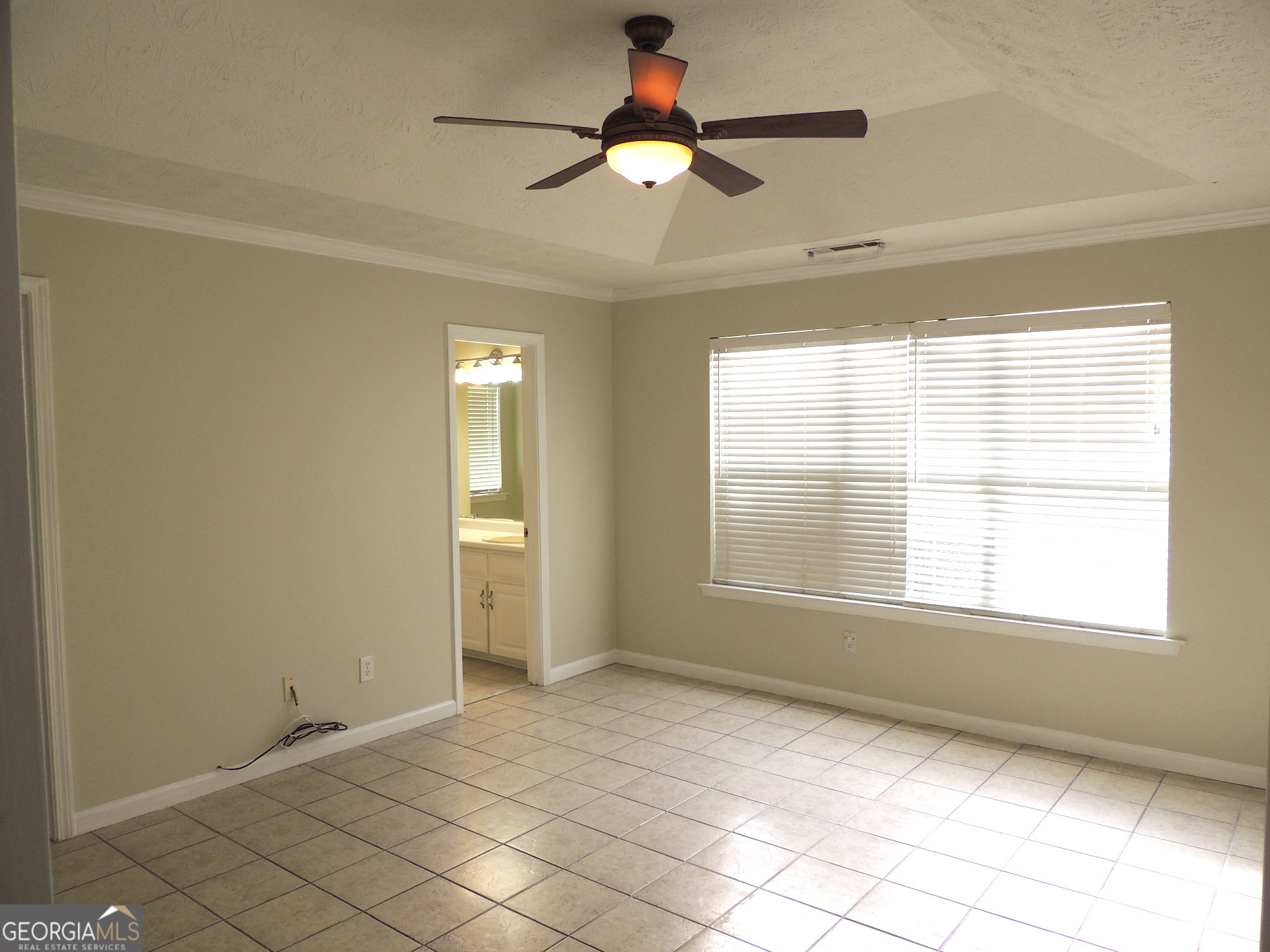 10 Brandon Drive Covington, GA 30016 - Photo 9 of 13 a view of an empty room with window chandelier fan and fire place