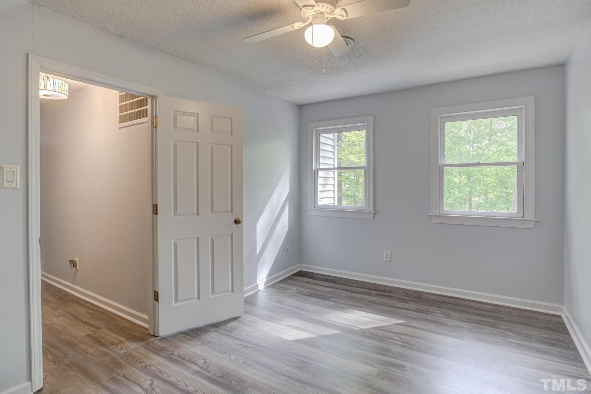 1416 Princess Anne Road Cary, NC 27513 - Photo 36 of 58 an empty room with wooden floor and windows