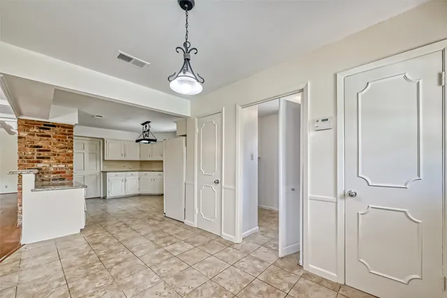 a view of a room with cabinet and a flat screen tv
