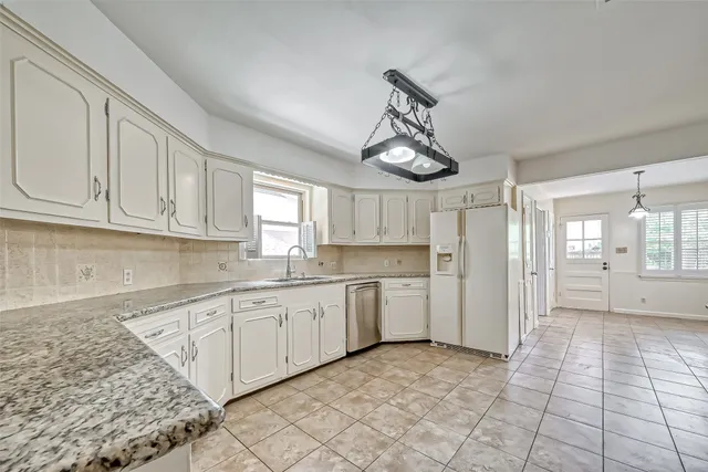 a open kitchen with stainless steel appliances granite countertop a sink and cabinets