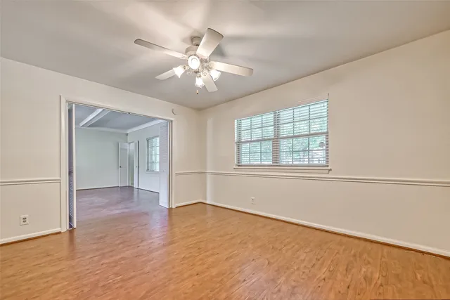 wooden floor in an empty room with a window