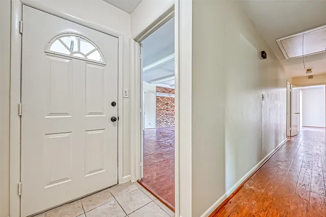 workspace with wooden floor mirror and windows