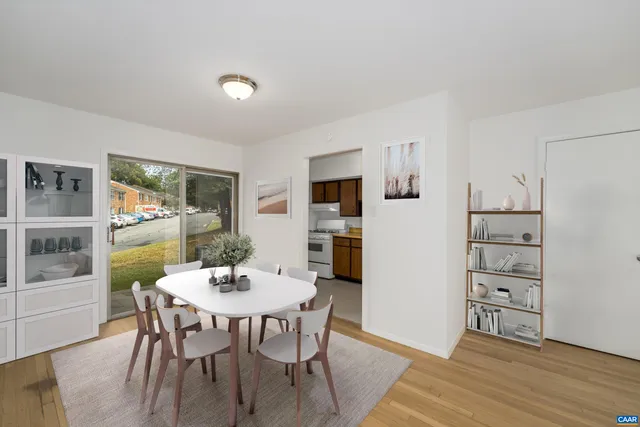 a view of a dining room with furniture window and wooden floor