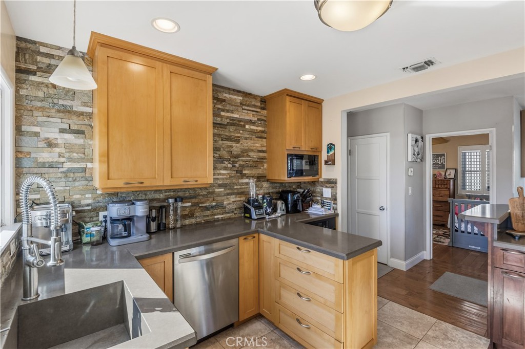 22709 Gaycrest Avenue Torrance, CA 90505 - Photo 10 of 22 a kitchen with stainless steel appliances a sink a stove and a refrigerator