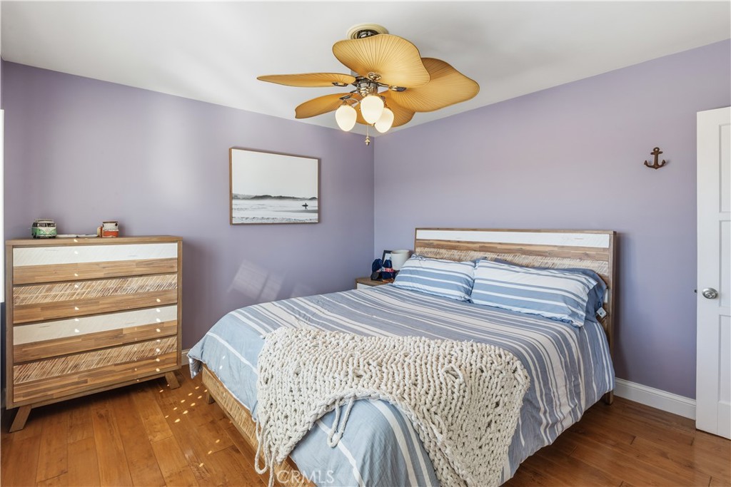 22709 Gaycrest Avenue Torrance, CA 90505 - Photo 11 of 22 a bedroom with a bed and a chandelier