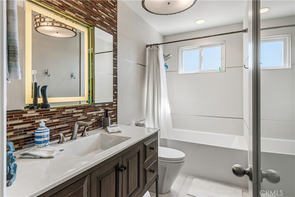 22709 Gaycrest Avenue Torrance, CA 90505 - Photo 13 of 22 a bathroom with a sink a toilet and shower