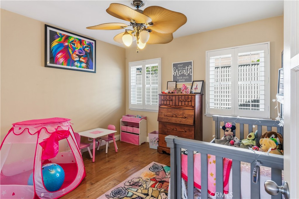 22709 Gaycrest Avenue Torrance, CA 90505 - Photo 14 of 22 a bedroom with a bed and a chandelier