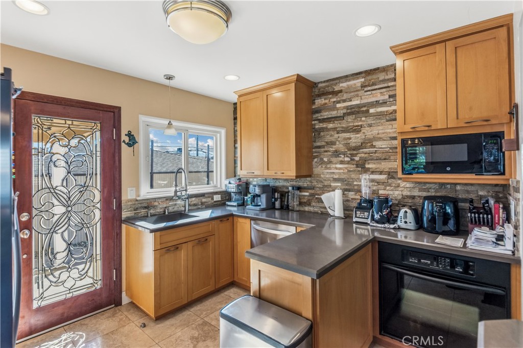 22709 Gaycrest Avenue Torrance, CA 90505 - Photo 9 of 22 a kitchen with a sink stove and cabinets