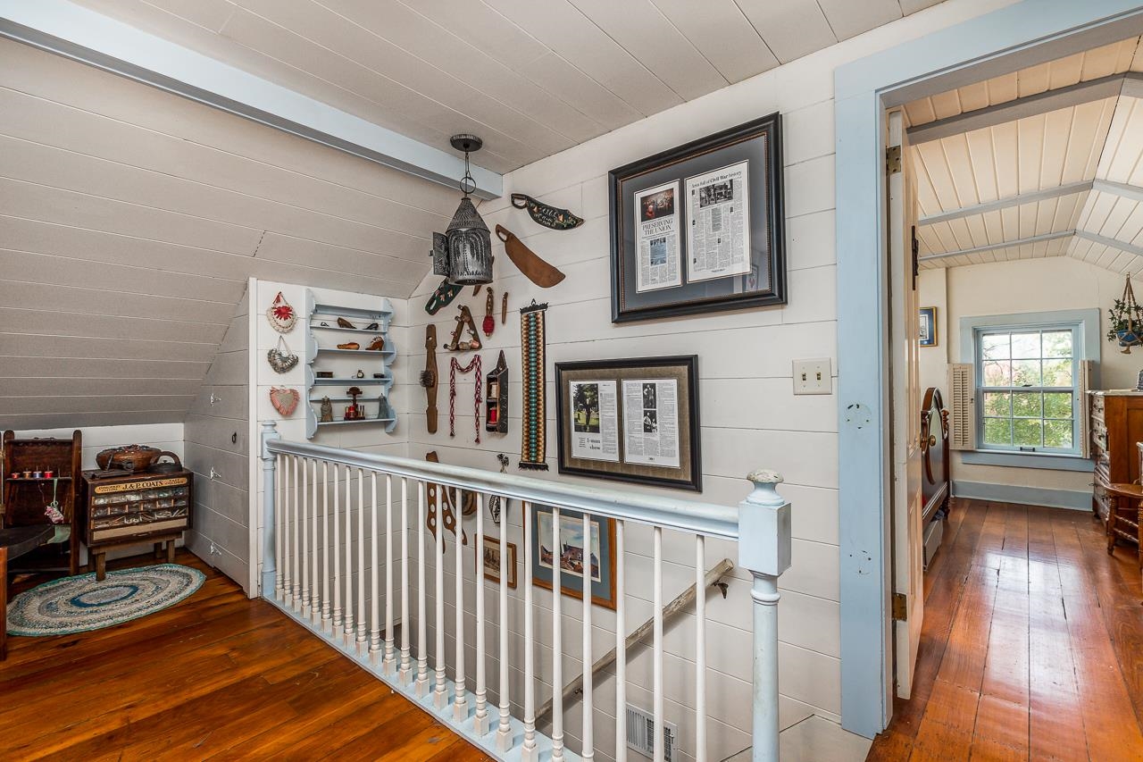 514 3rd Street Galena, IL 61036 - Photo 18 of 25 a view of a hallway to a livingroom with wooden floor and furniture