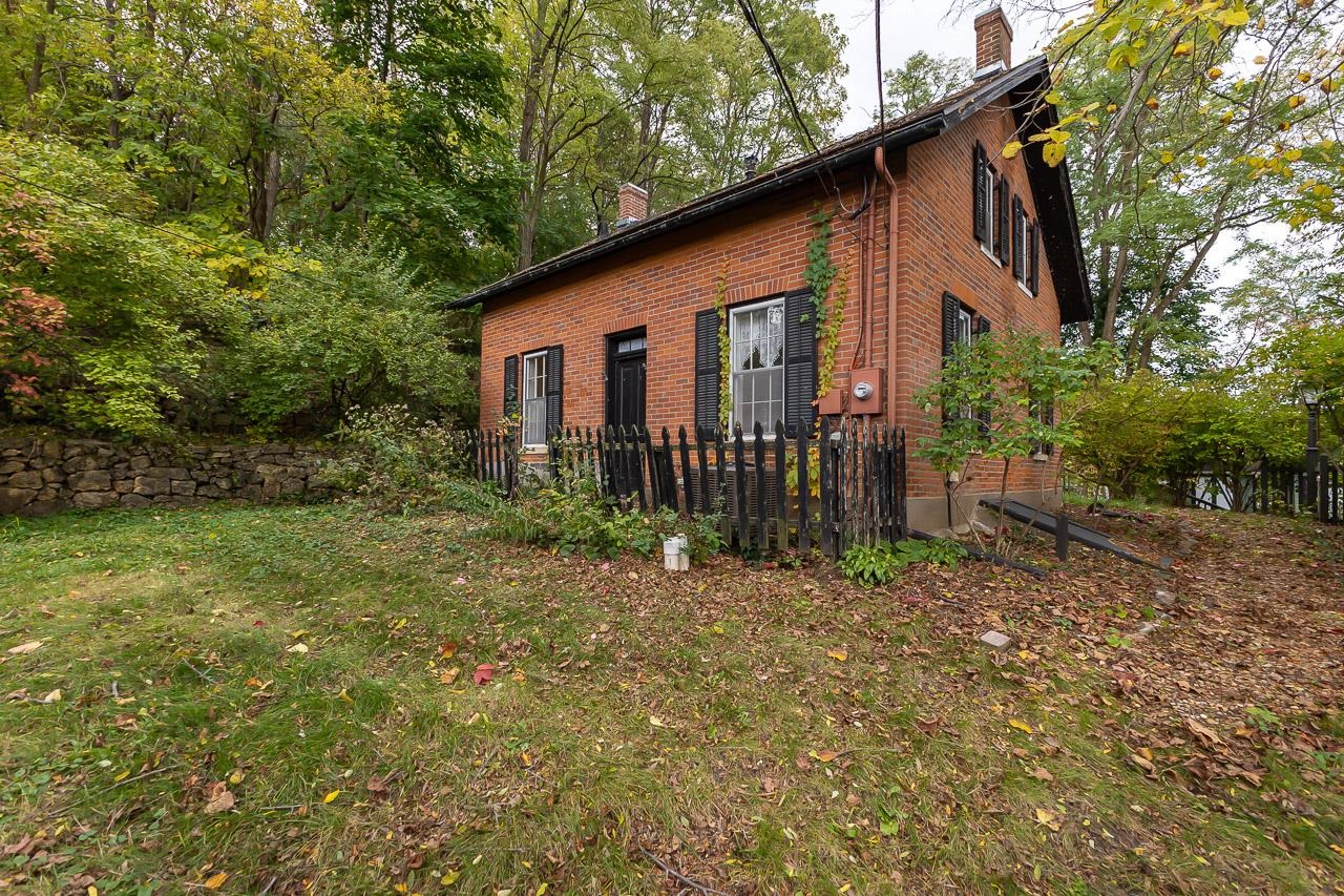 514 3rd Street Galena, IL 61036 - Photo 2 of 25 a backyard of a house with plants and tree