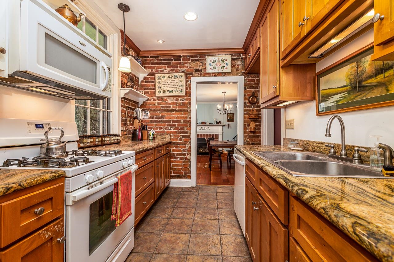 514 3rd Street Galena, IL 61036 - Photo 7 of 25 a kitchen with stainless steel appliances granite countertop a sink and stove
