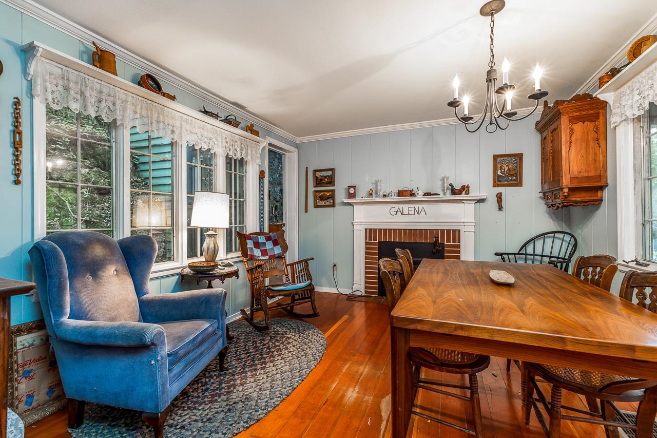 514 3rd Street Galena, IL 61036 - Photo 8 of 25 a dining room with furniture a fireplace and a chandelier