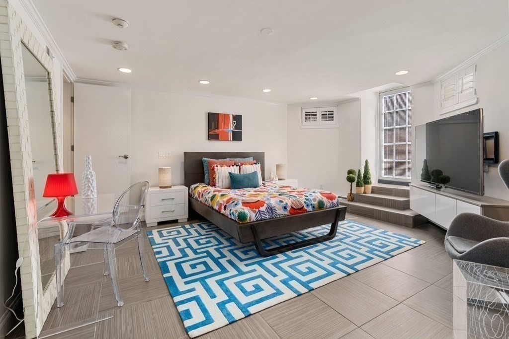 352 Commonwealth Avenue, Unit 2 Boston, MA 02115 - Photo 15 of 25 a bedroom with a bed and flat screen tv