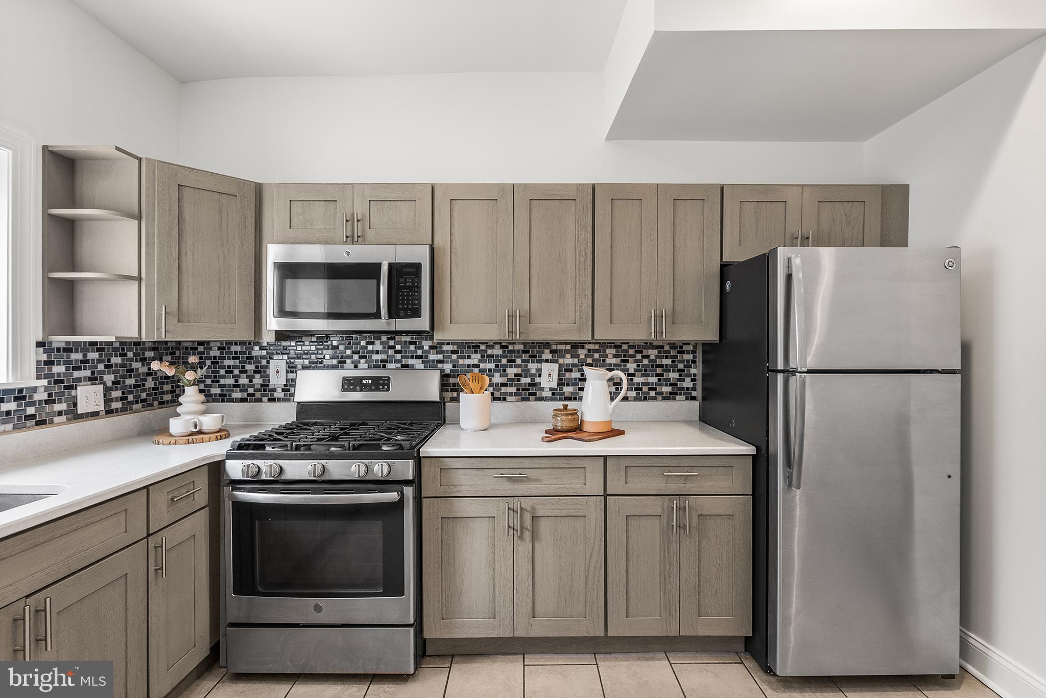 902 Emily Street Philadelphia, PA 19148 - Photo 7 of 25 Updated kitchen with stainless steel appliances