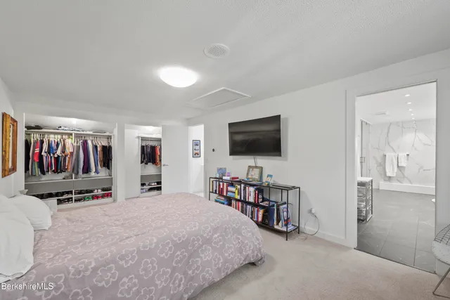 a bedroom with furniture and a flat screen tv