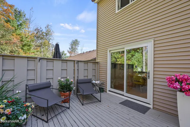 a view of a deck with furniture and potted plants