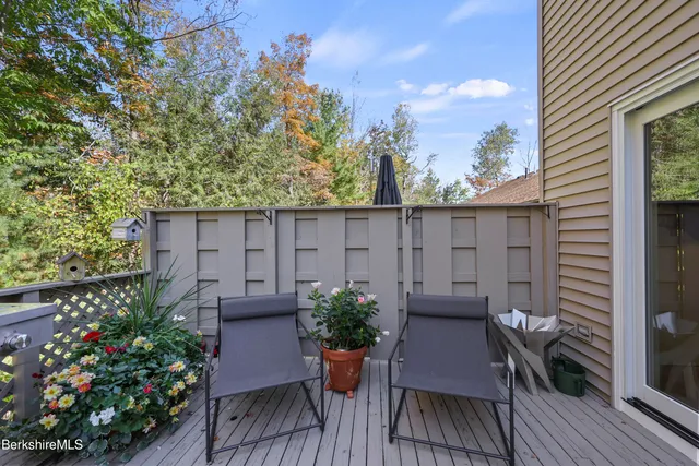 a view of balcony with chairs and wooden fence
