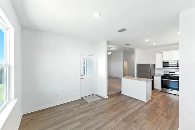 a view of kitchen with sink and refrigerator