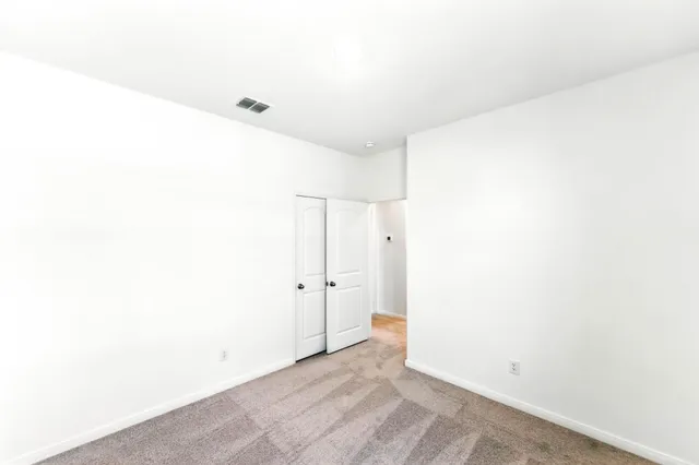 a bathroom with a granite countertop sink a toilet and a mirror