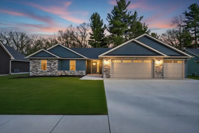 a front view of a house with a garden