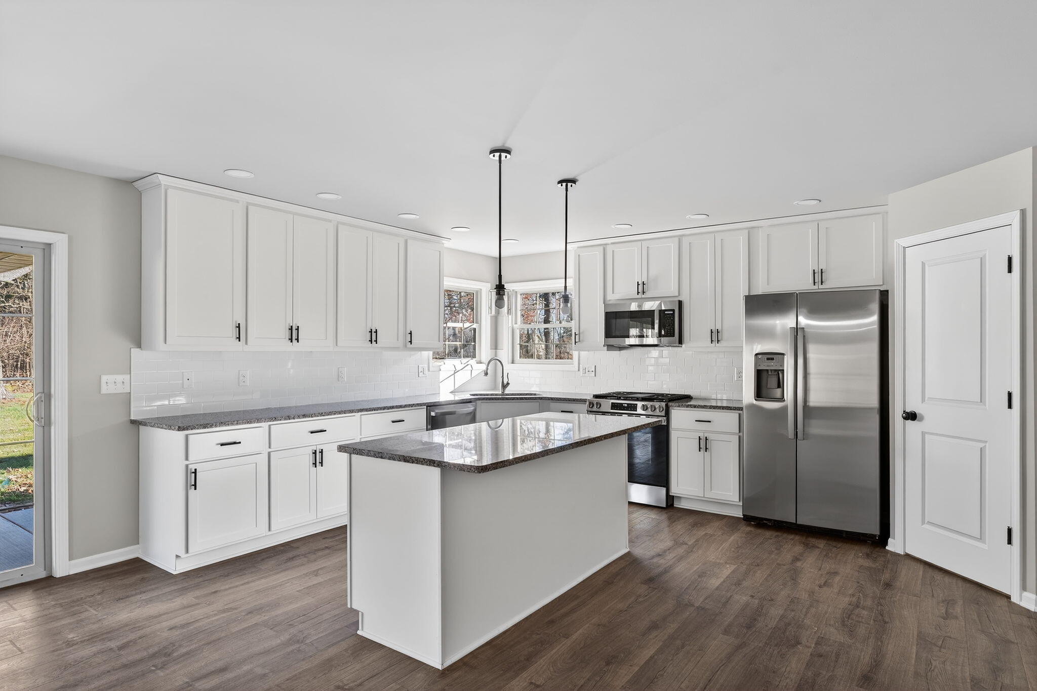 1611 Elderberry Street Southeast De Motte, IN 46310 - Photo 13 of 31 a kitchen with stainless steel appliances granite countertop a sink stove and refrigerator