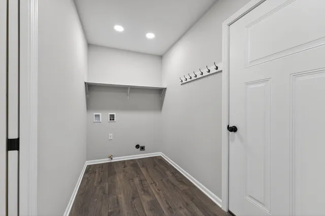 a view of a hallway to a room with wooden floor