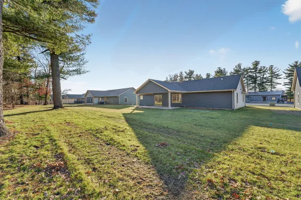 a view of a house with a yard and garage