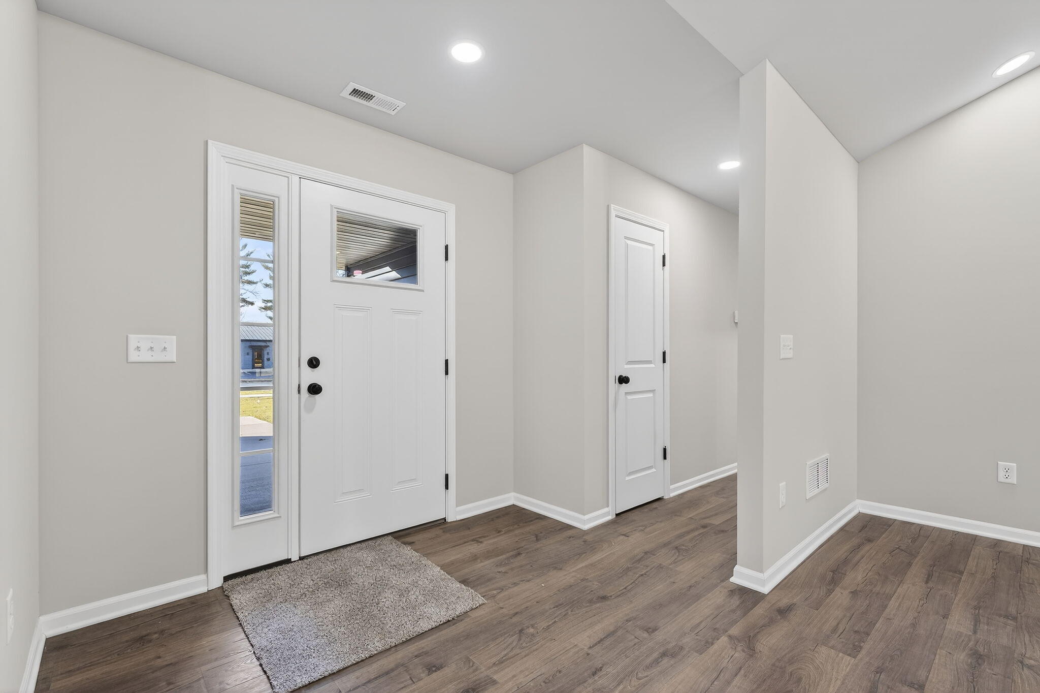 1611 Elderberry Street Southeast De Motte, IN 46310 - Photo 6 of 31 an empty room with wooden floor & wooden door