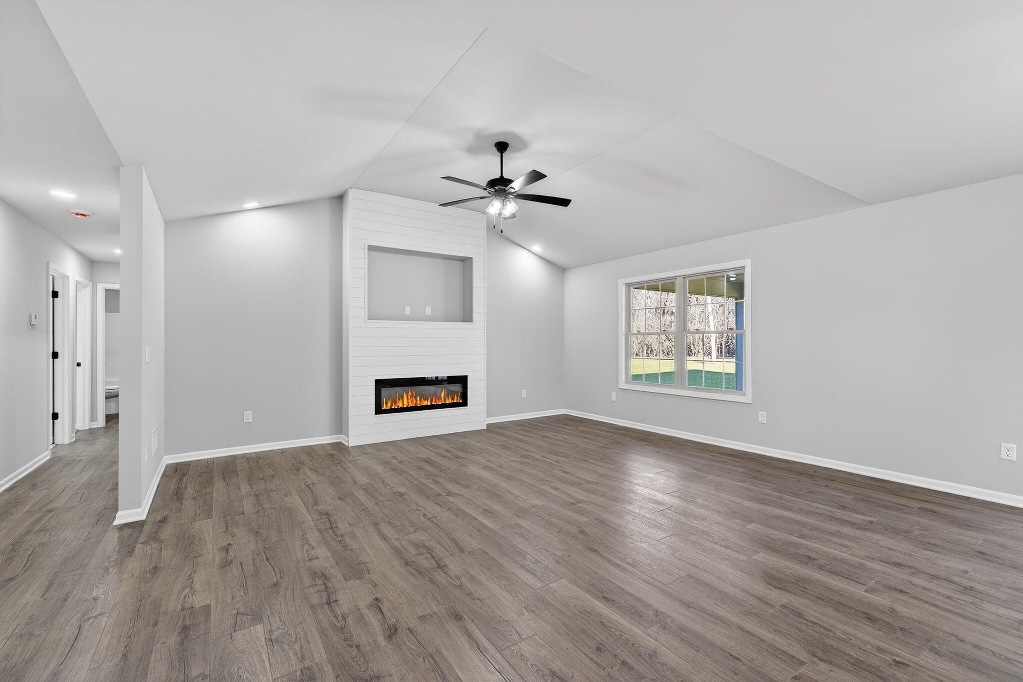 1611 Elderberry Street Southeast De Motte, IN 46310 - Photo 7 of 31 a view of an empty room with a fireplace and a window