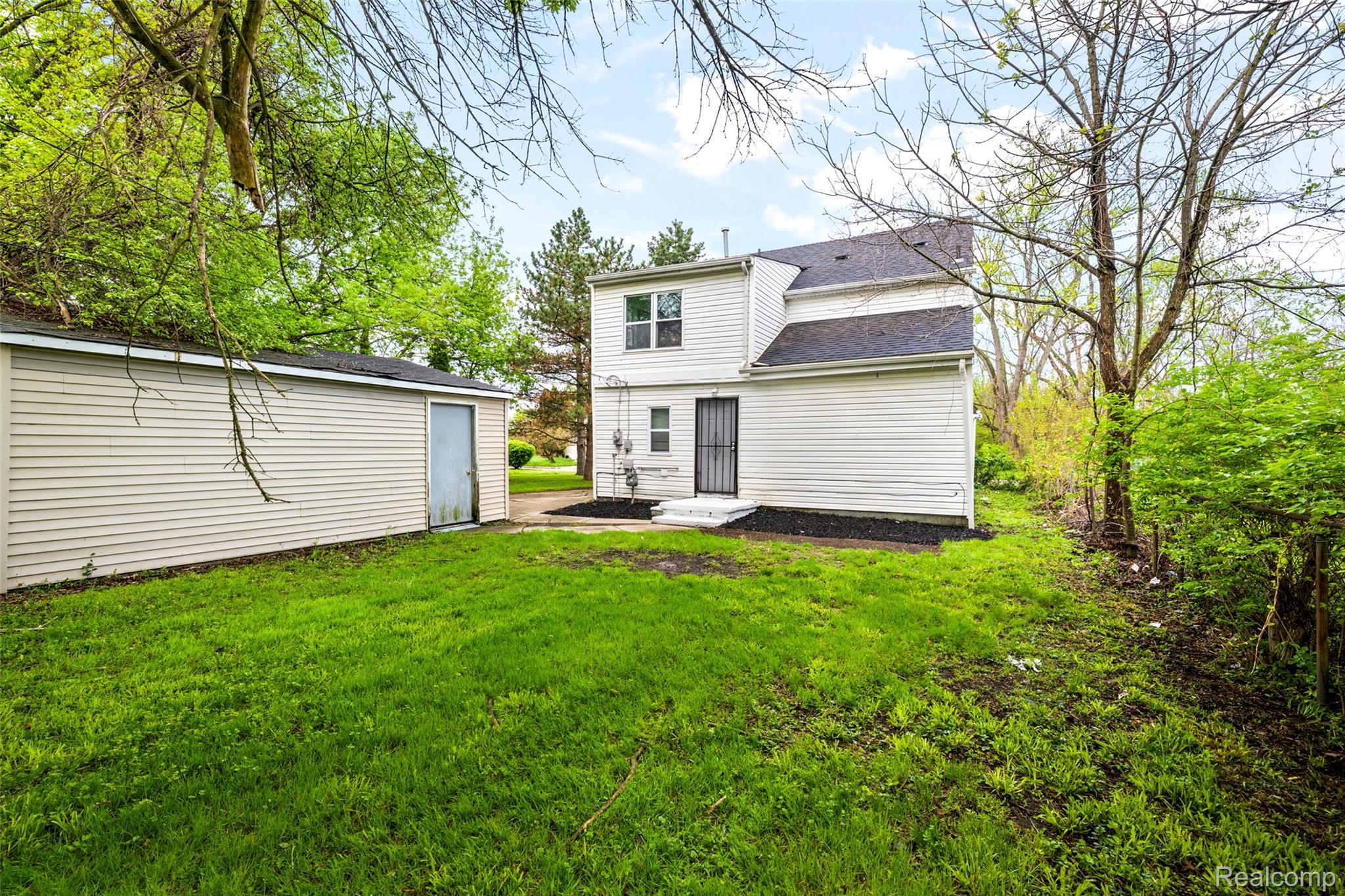 3605 Ash Street Inkster, MI 48141 - Photo 25 of 25 Rear view of house featuring a lawn, a patio area, and roof with shingles