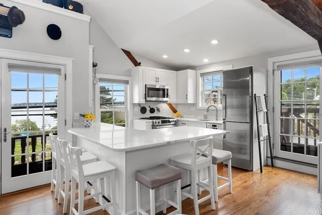 a kitchen with stainless steel appliances granite countertop a stove refrigerator and a wooden cabinets