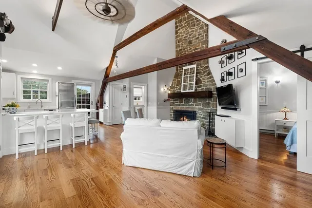 a living room with furniture a fireplace and a flat screen tv