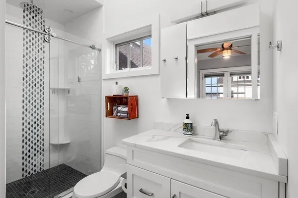 a bathroom with a sink toilet and shower