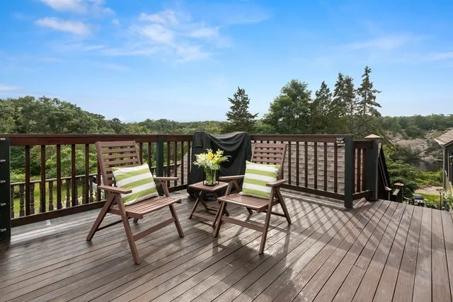 a view of balcony with wooden floor and outdoor seating