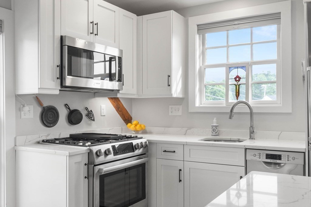 46 Granite Street, Unit DWINTER Rockport, MA 01966 - Photo 9 of 23 a kitchen with a stove and a microwave