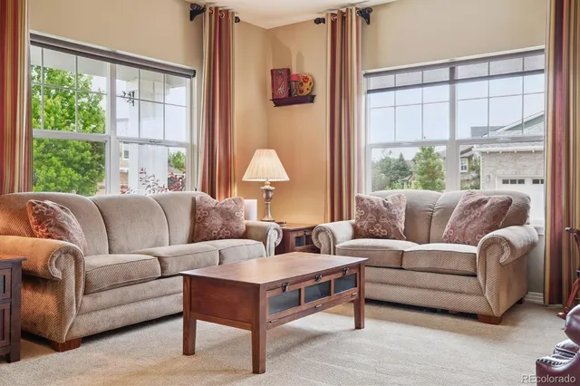 a living room with furniture and a large window