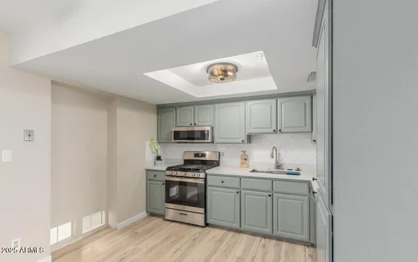 a kitchen with kitchen island white cabinets and appliances